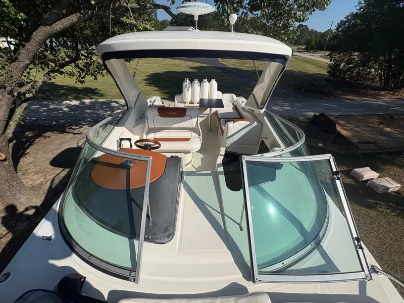 Slide: The Image of A 2010 Sea Ray Sundancer 310 with an open cockpit and comfortable seating. - 15
