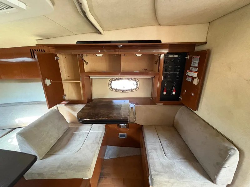 Slide: The Image of Interior of the 2010 Sea Ray Sundancer 310 with seating area and wooden cabinetry. - 21