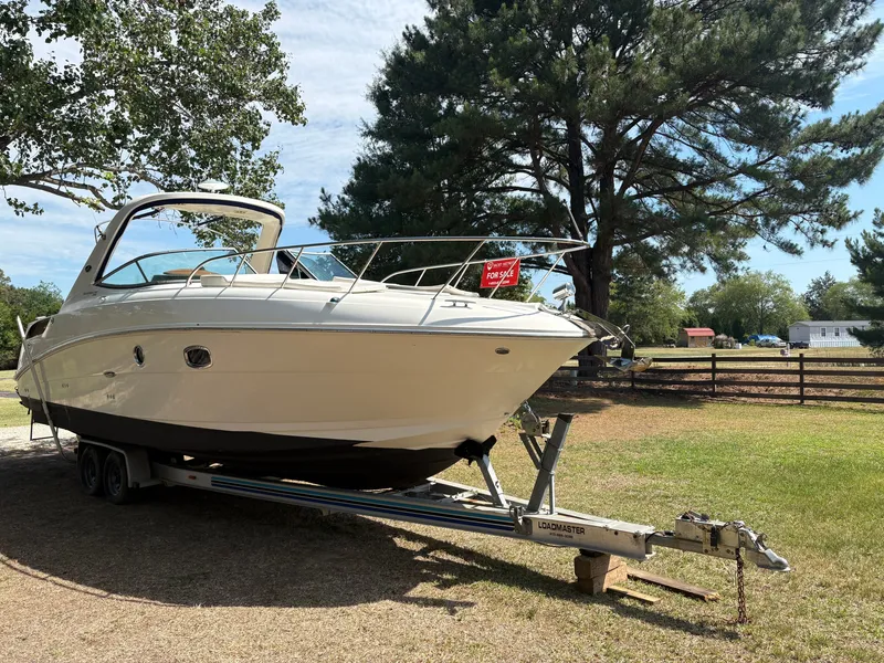 Slide: The Image of A 2010 Sea Ray Sundancer 310 on a trailer in a grassy area. - 9