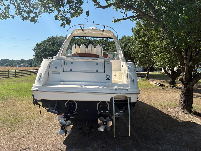 Slide: The Image of A 2010 Sea Ray Sundancer 310 is on dry land under a tree. - 43