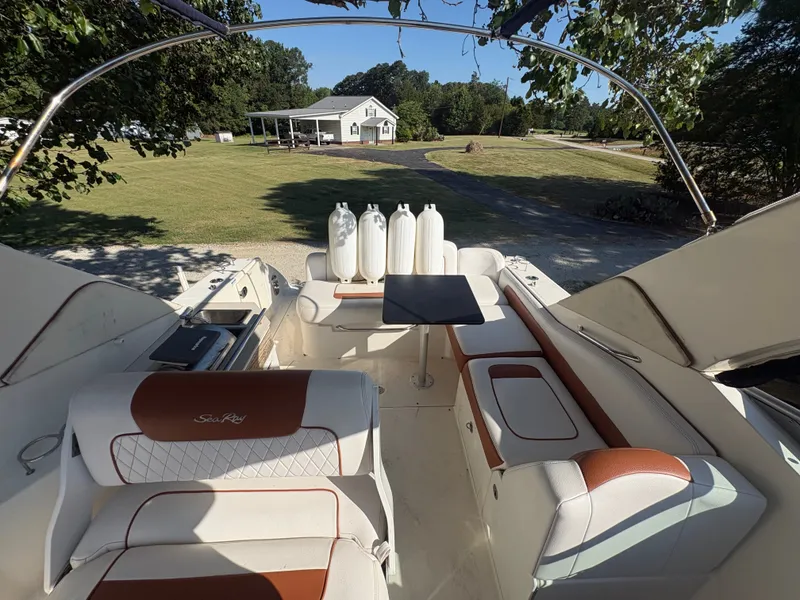 Slide: The Image of The image shows the cockpit of a Sea Ray Sundancer 310 with white and brown seating. - 14