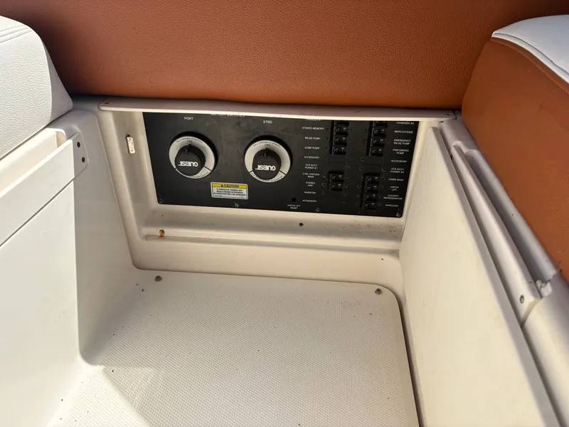 Slide: The Image of The image shows the control panel of a 2010 Sea Ray Sundancer 310. - 13