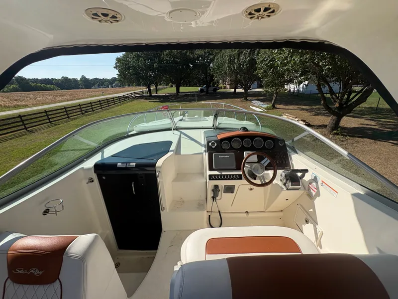 Slide: The Image of The image shows the cockpit of a 2010 Sea Ray Sundancer 310 with a sleek helm. - 10