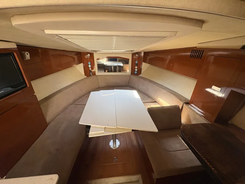 Slide: The Image of Interior of a 2010 Sea Ray Sundancer 310 with a cozy seating area and table. - 20