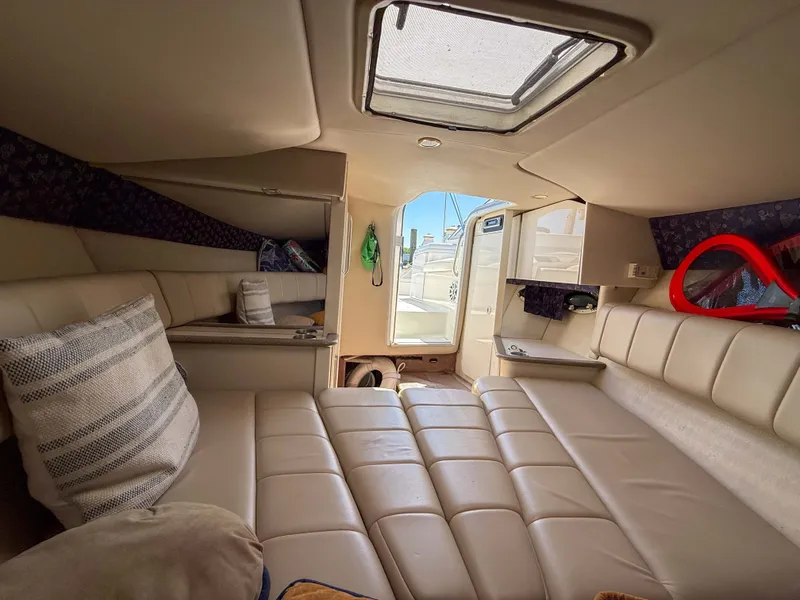 Slide: The Image of Interior of a 2001 Formula 280 Sun Sport with cream-colored upholstery and a skylight. - 17
