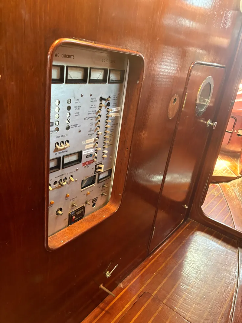 Slide: The Image of Electrical control panel in a 1980 Gulfstar 50 CC Ketch, surrounded by wood paneling. - 29