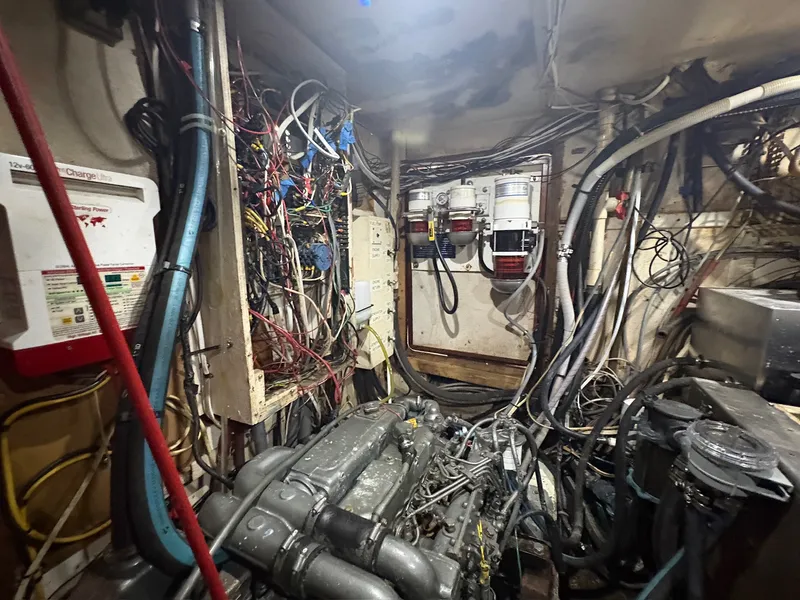 Slide: The Image of The engine room of a 1980 Gulfstar 50 CC Ketch shows complex wiring and machinery. - 50