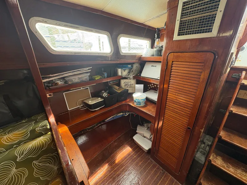Slide: The Image of Interior of a 1980 Gulfstar 50 CC Ketch with wood paneling and storage space. - 22