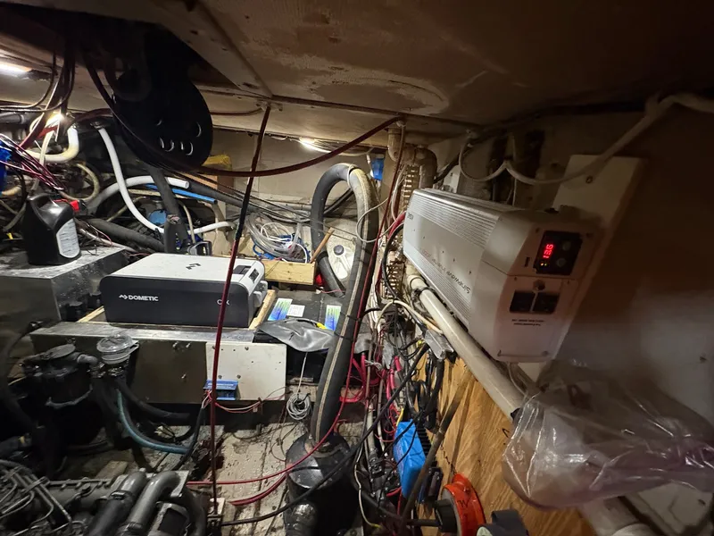 Slide: The Image of The engine room of a 1980 Gulfstar 50 CC Ketch shows complex wiring and equipment. - 48