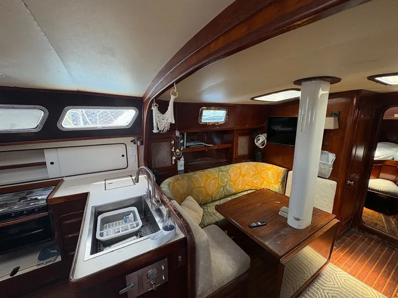 Slide: The Image of Interior of a 1980 Gulfstar 50 CC Ketch with cozy seating area and kitchen. - 24
