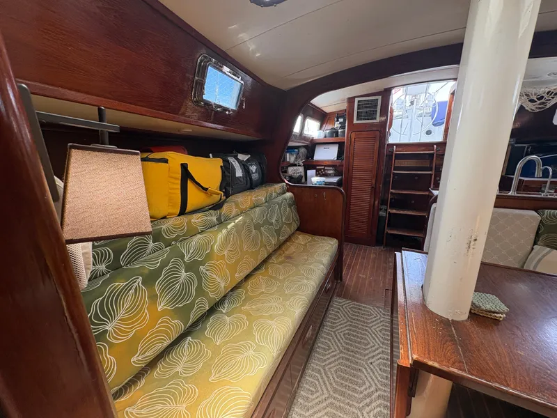 Slide: The Image of Interior of a 1980 Gulfstar 50 CC Ketch with cozy seating and wood finishes. - 19
