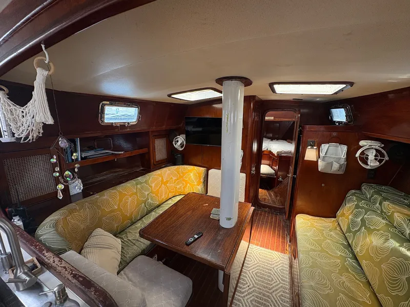 Slide: The Image of Interior of a 1980 Gulfstar 50 CC Ketch with cozy seating area and wooden table. - 41
