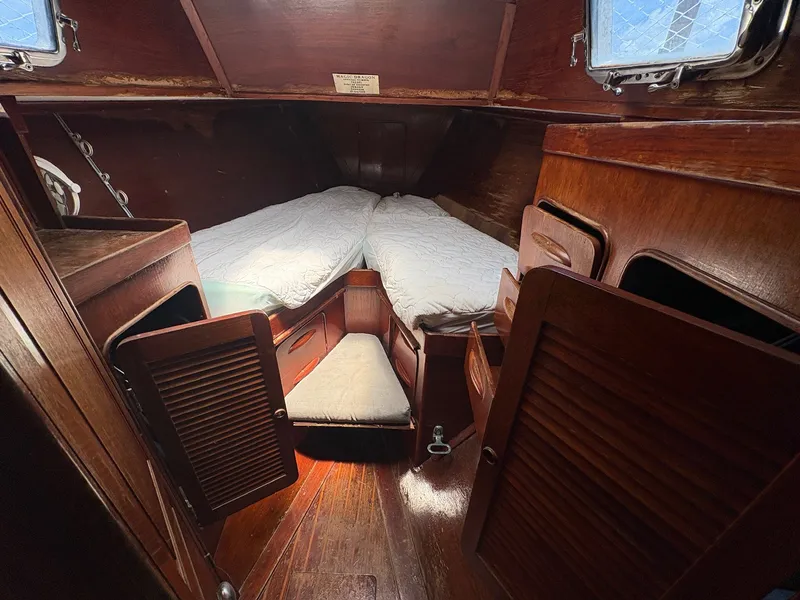 Slide: The Image of Interior of a 1980 Gulfstar 50 CC Ketch with wood finish and sleeping area. - 44