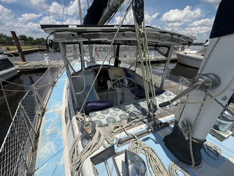 Slide: The Image of The image shows a 1980 Gulfstar 50 CC Ketch docked. The deck features ropes and a steering wheel. - 17