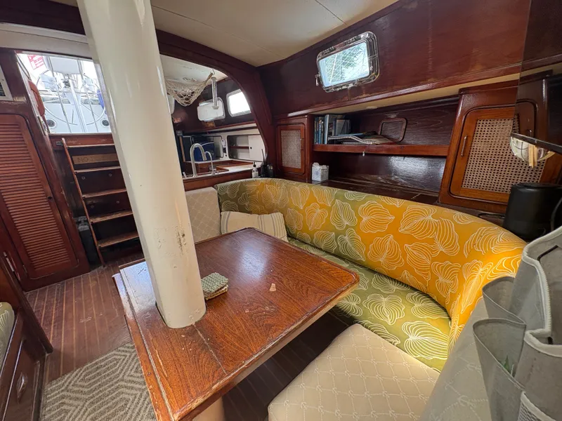 Slide: The Image of Interior of a 1980 Gulfstar 50 CC Ketch with a cozy seating area and wooden table. - 20