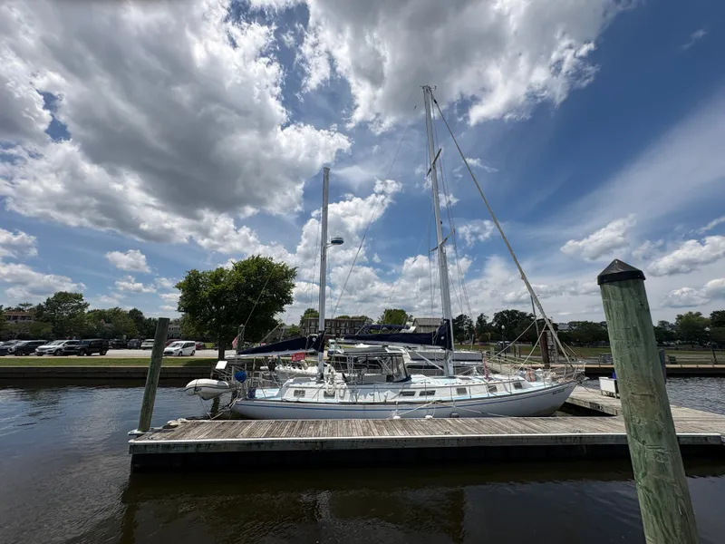 The Image of A 1980 Gulfstar 50 CC Ketch docked peacefully under a cloudy sky. - 1