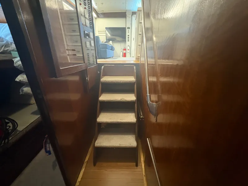 Slide: The Image of Interior of a 1973 Hatteras 53 Convertible with stairs and wooden walls. - 29