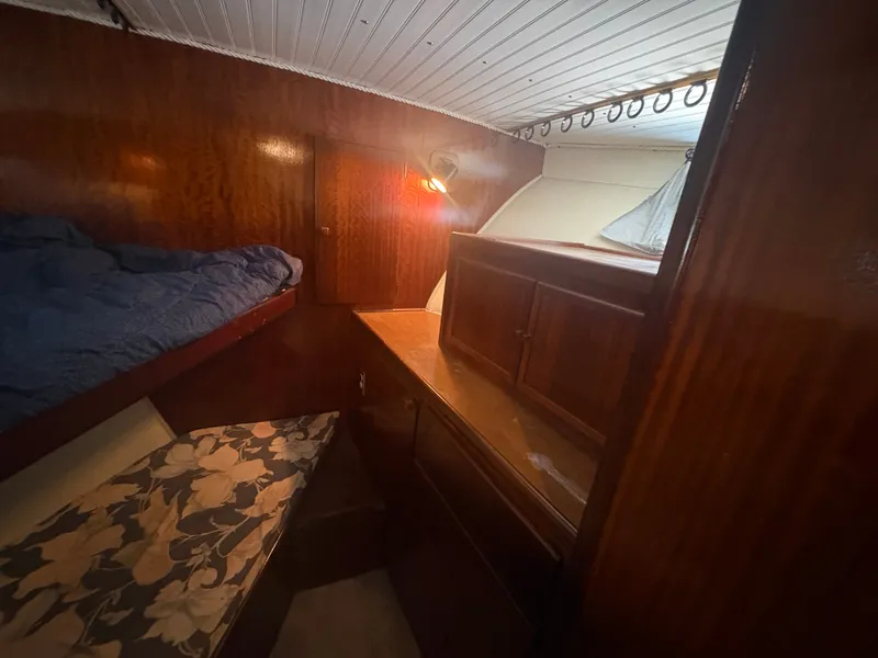 Slide: The Image of Interior of a 1973 Hatteras 53 Convertible with wooden furnishings and cozy lighting. - 40