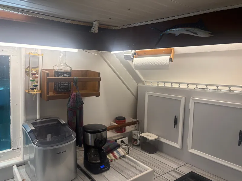 Slide: The Image of The kitchen of a 1973 Hatteras 53 Convertible with a coffee maker and ice maker. - 26