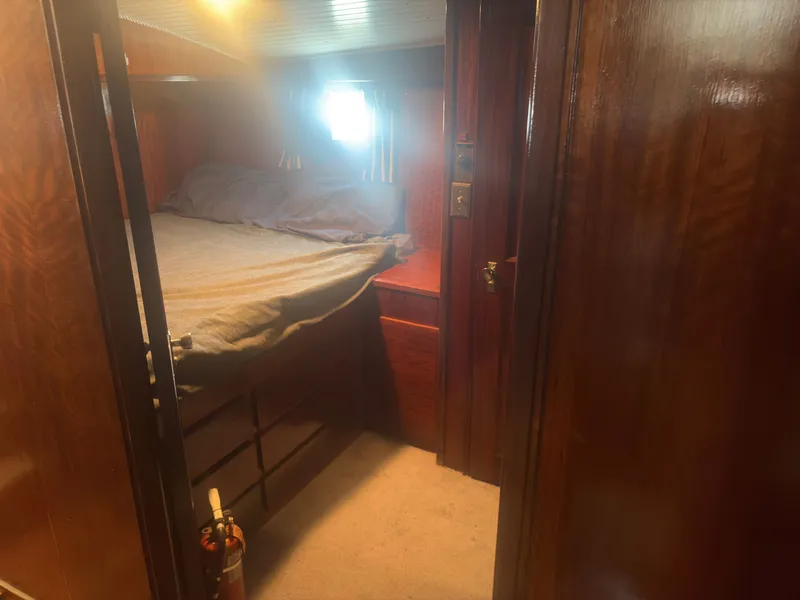 Slide: The Image of A cozy bedroom with wooden walls and a bed illuminated by a small window. - 45