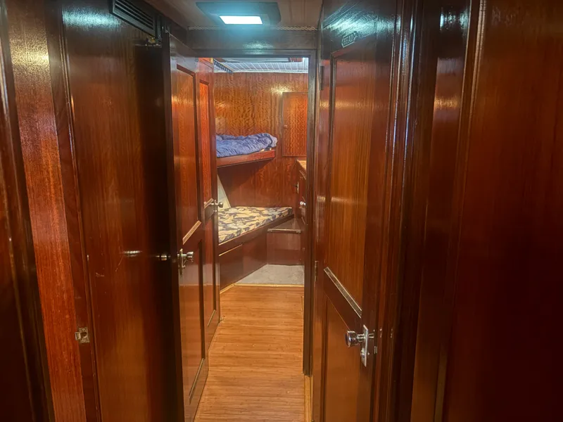 Slide: The Image of A sleek interior with wooden walls and bunk beds in a 1973 Hatteras 53 Convertible. - 32
