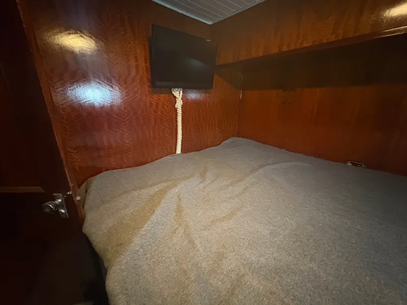 Slide: The Image of Interior of a 1973 Hatteras 53 Convertible with a cozy bed and a TV. - 50