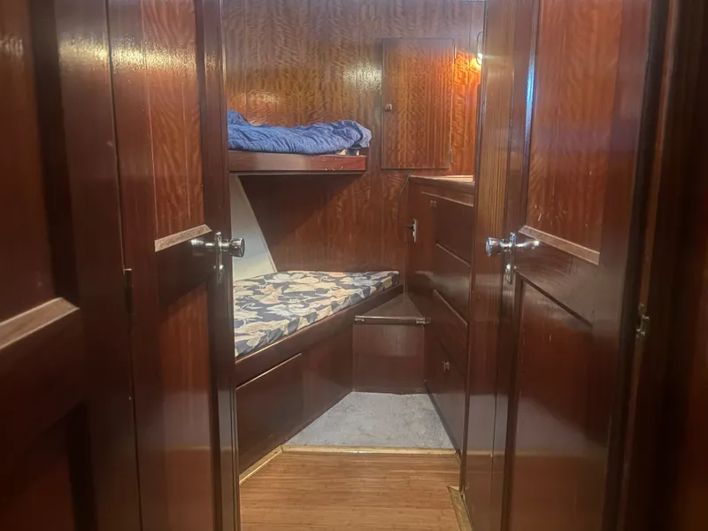 Slide: The Image of Interior of a 1973 Hatteras 53 Convertible with wood paneling and a bunk bed. - 35