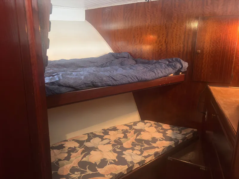 Slide: The Image of Interior of a 1973 Hatteras 53 Convertible with bunk beds and wood paneling. - 36