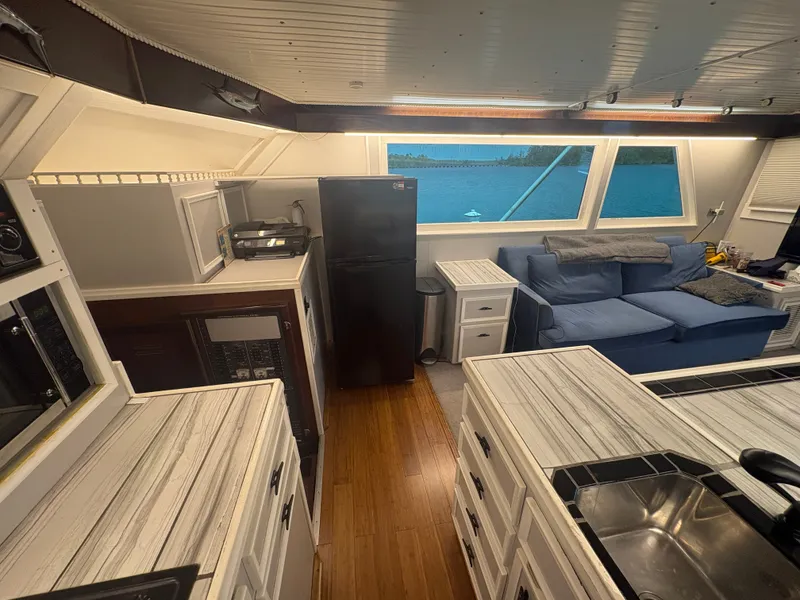 Slide: The Image of Interior of a 1973 Hatteras 53 Convertible with a modern kitchen and cozy living area. - 22