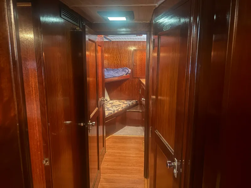 Slide: The Image of Interior of a 1973 Hatteras 53 Convertible with wooden walls and bunk beds. - 33