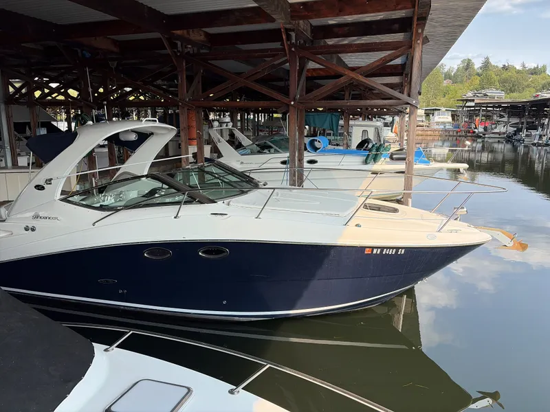 The Image of A 2007 Sea Ray 290 Sundancer docked in a covered marina. - 1