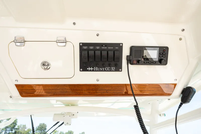 Slide: The Image of 2024 Hunt Yachts 32CC control panel with Garmin device and storage compartment. - 25