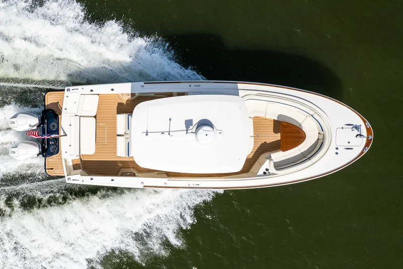 Slide: The Image of Aerial view of 2024 Hunt Yachts 32CC cruising on water, showcasing sleek design and powerful engines. - 10