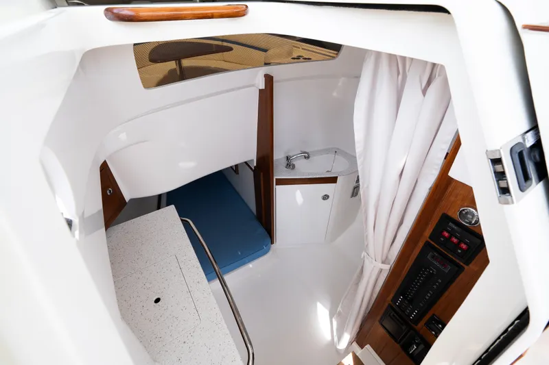 Slide: The Image of 2024 Hunt Yachts 32CC cabin interior with sink, seating, and control panel. - 29