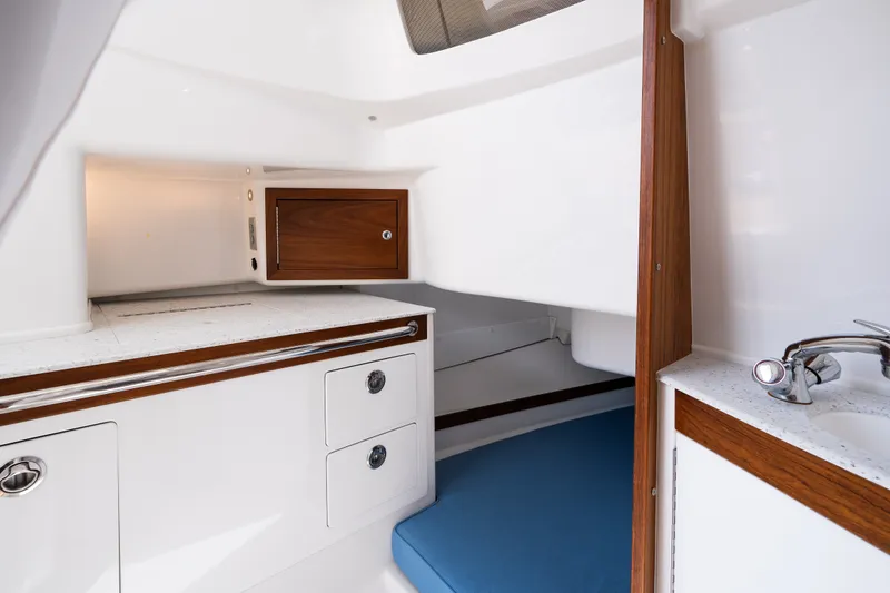 Slide: The Image of 2024 Hunt Yachts 32CC cabin interior with wood accents and modern amenities. - 30