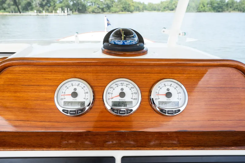 Slide: The Image of Dashboard of 2024 Hunt Yachts 32CC with wooden finish and gauges. - 24