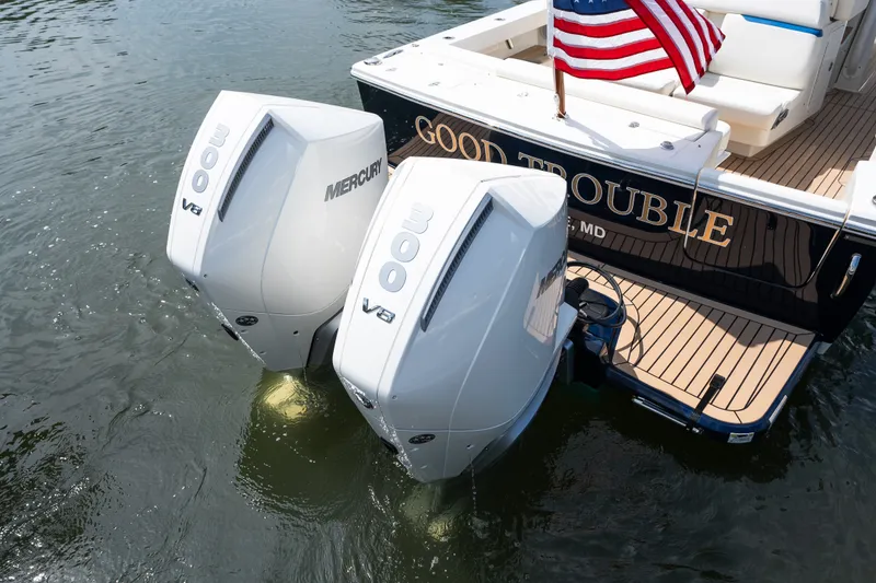 Slide: The Image of 2024 Hunt Yachts 32CC with twin Mercury 300 V8 engines, American flag displayed. - 3