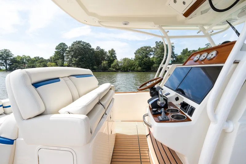 Slide: The Image of 2024 Hunt Yachts 32CC interior with helm, luxurious seating, and scenic water view. - 27
