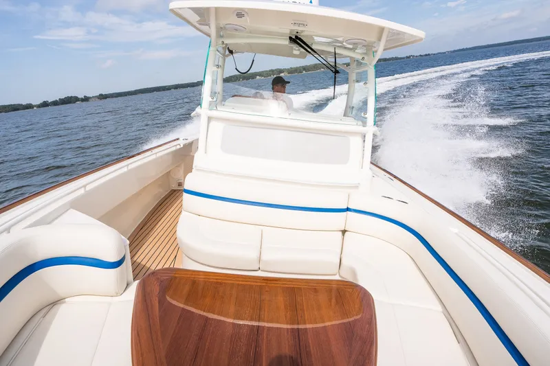 Slide: The Image of 2024 Hunt Yachts 32CC cruising on open water, showcasing elegant seating and sleek design. - 15