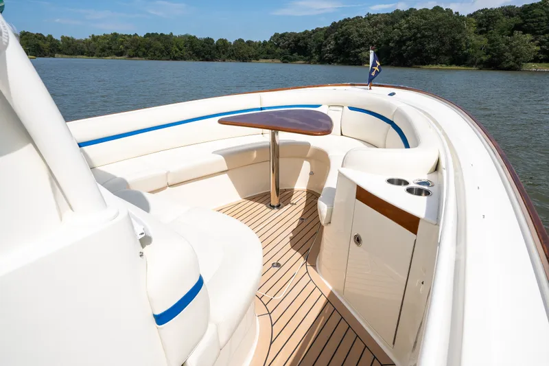 Slide: The Image of 2024 Hunt Yachts 32CC boat interior with seating and table on calm water. - 35