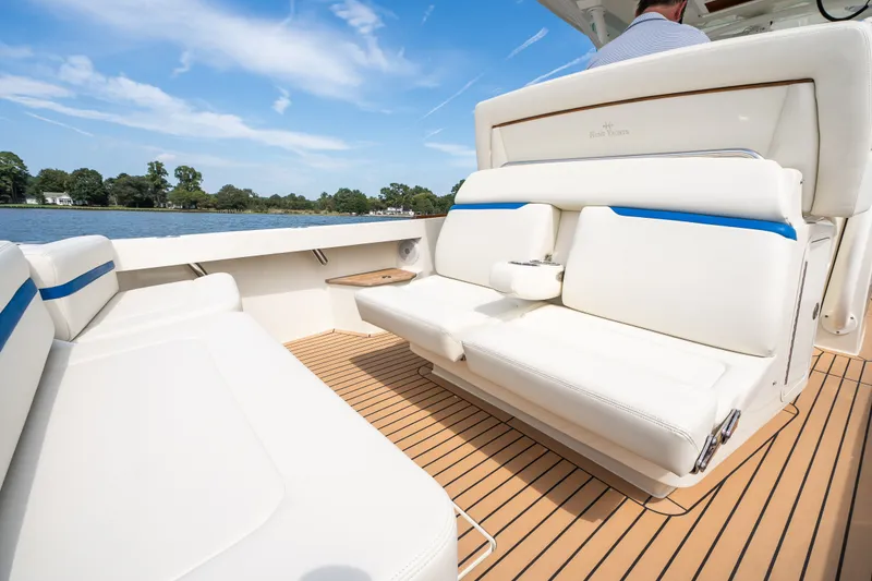 Slide: The Image of 2024 Hunt Yachts 32CC interior with luxurious white seating and wooden deck. - 14