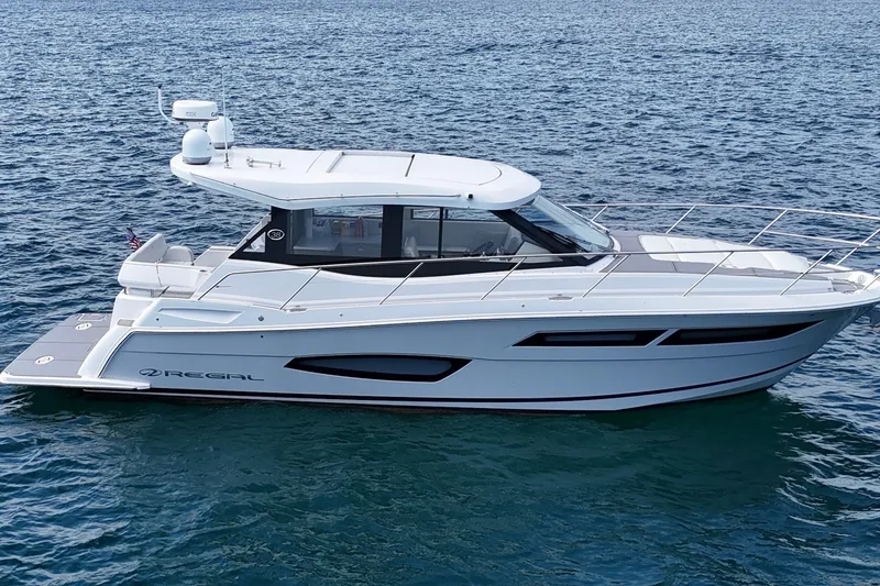 The Image of 2021 Regal 38 Grande Coupe yacht cruising on open water. - 0