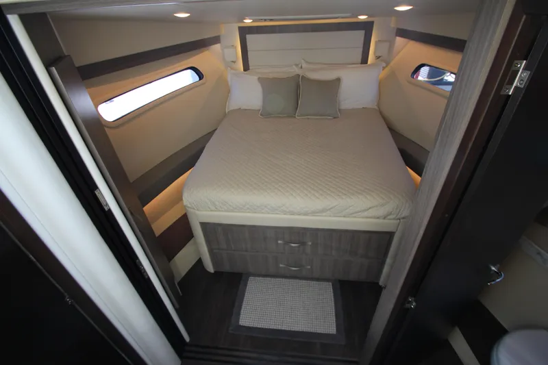 Slide: The Image of Die Kabine der Regal 38 Grande Coupe 2021 zeigt ein gemütliches Bett mit Kissen und seitlichen Fenstern. - 46