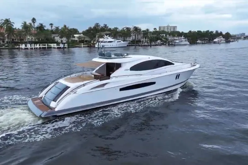 Slide: The Image of Eine elegante Lazzara LSX 75 Yacht von 2008 fährt auf einem ruhigen Wasserweg. - 3