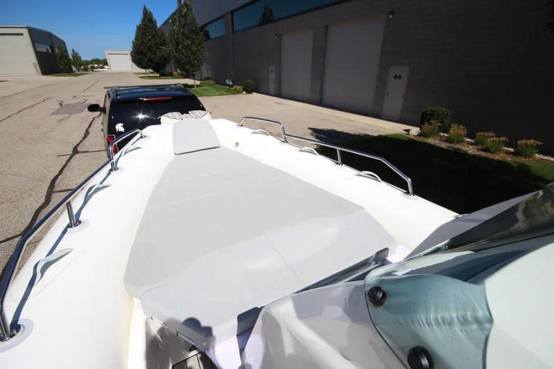 Slide: The Image of 2023 Zodiac Medline 7.5 boat on trailer, parked near industrial buildings. - 23