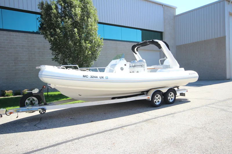 Slide: The Image of 2023 Zodiac Medline 7.5 boat on trailer, parked outside industrial building. - 1