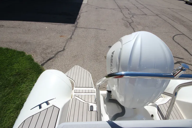 Slide: The Image of 2023 Zodiac Medline 7.5 boat with Yamaha outboard engine, docked on pavement. - 7