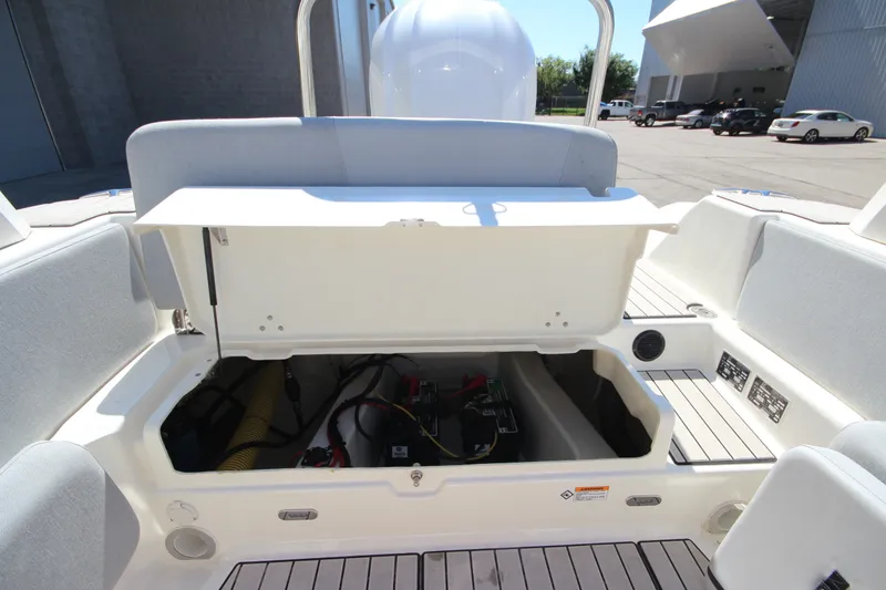 Slide: The Image of 2023 Zodiac Medline 7.5 boat storage compartment with open hatch, revealing interior components. - 14