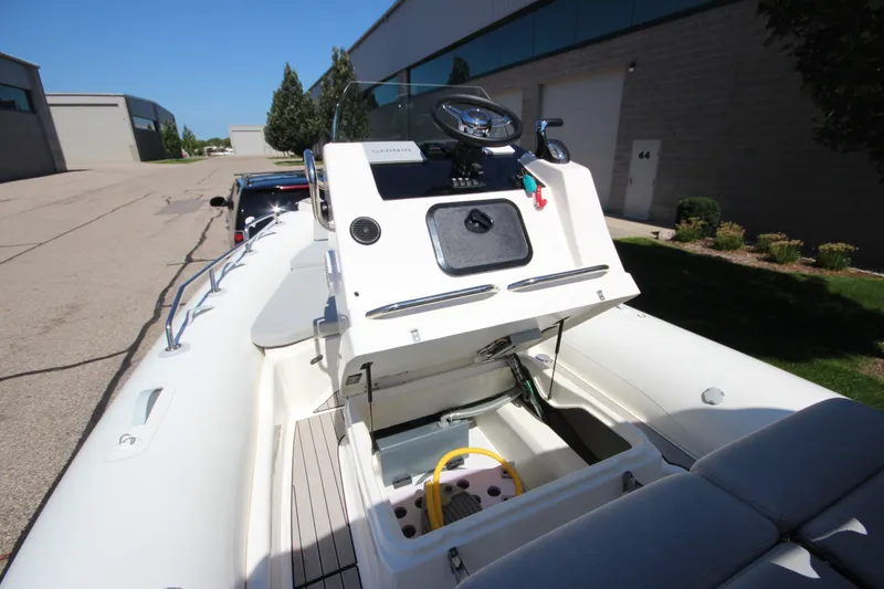 Slide: The Image of 2023 Zodiac Medline 7.5 boat interior with open storage compartment. - 31