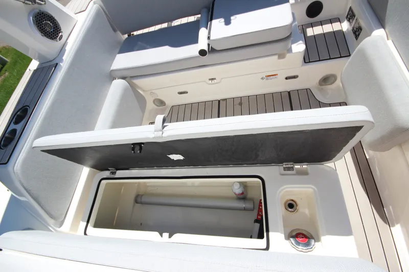 Slide: The Image of 2023 Zodiac Medline 7.5 boat interior storage compartment with open lid and seating. - 16
